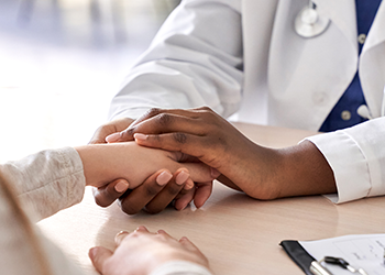 Doctor holding a patient's hand