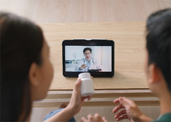Two people watching an instructional video