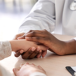 Doctor holding a patient's hand