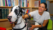 Nancy enjoys reading while her service dog, Shelby, takes a break. Photo by Thomas N. Ullom, Medical Media, Chalmers P. Wylie VA Ambulatory Care Center, Columbus, Ohio.